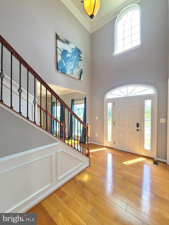 9423 Reservoir Rd, Fredericksburg, VA 22407 - foyer with a high ceiling, stairway, crown molding, wood finished floors, and healthy amount of natural light