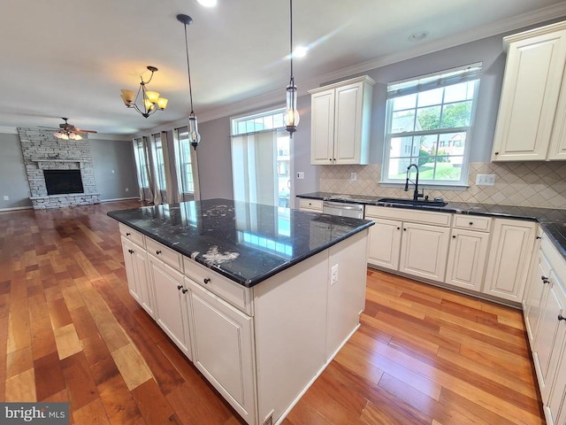 9423 Reservoir Rd, Fredericksburg, VA 22407 - kitchen featuring a sink, ornamental molding, a fireplace, decorative backsplash, and open floor plan