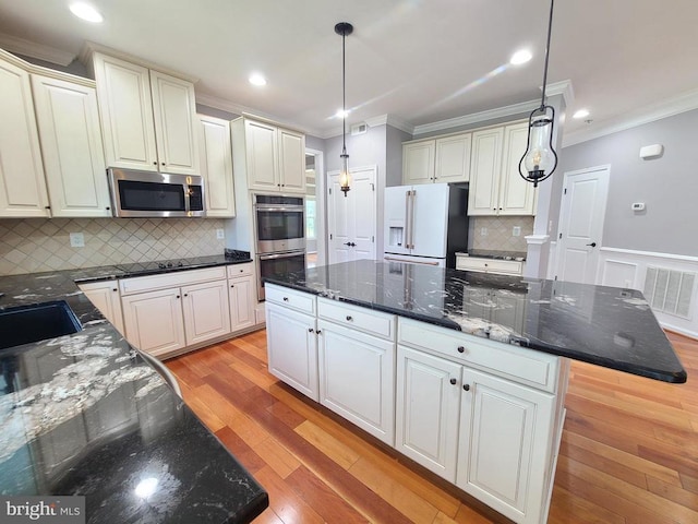9423 Reservoir Rd, Fredericksburg, VA 22407 - kitchen featuring stainless steel appliances, crown molding, a sink, light wood-style floors, and hanging light fixtures