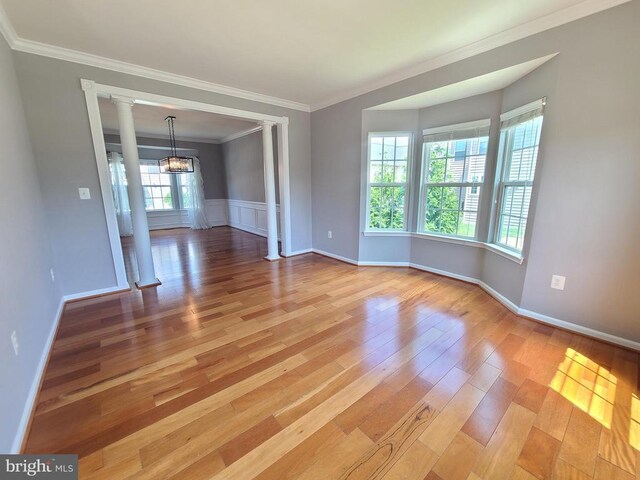 9423 Reservoir Rd, Fredericksburg, VA 22407 - unfurnished room featuring ornate columns, light wood finished floors, a chandelier, and crown molding