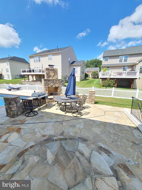 9423 Reservoir Rd, Fredericksburg, VA 22407 - view of patio / terrace with an outdoor stone fireplace and a residential view