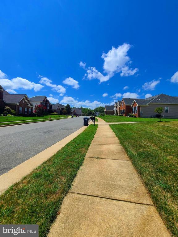 9423 Reservoir Rd, Fredericksburg, VA 22407 - view of asphalt street with sidewalks, a residential view, and curbs