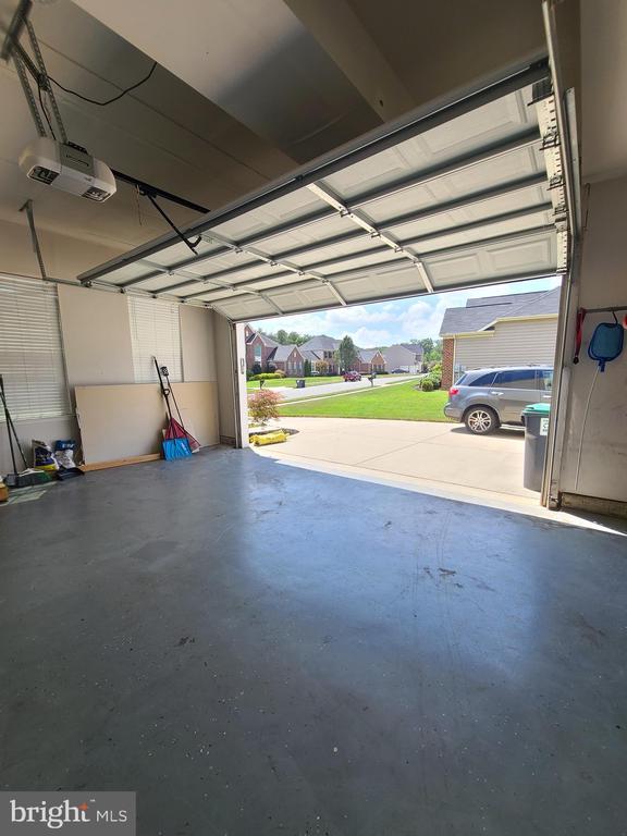 9423 Reservoir Rd, Fredericksburg, VA 22407 - garage featuring a garage door opener and a residential view