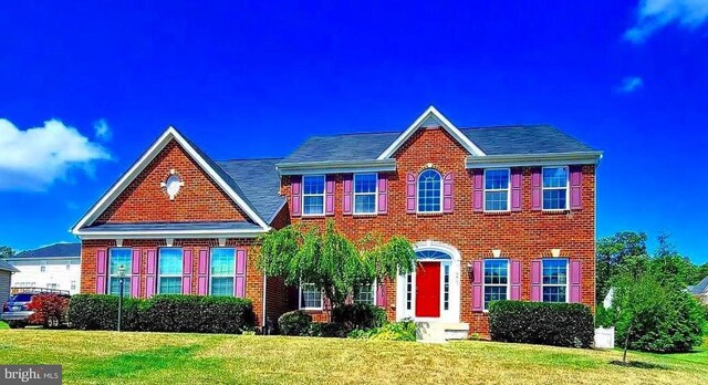 9423 Reservoir Rd, Fredericksburg, VA 22407 - georgian-style home with a front yard and brick siding