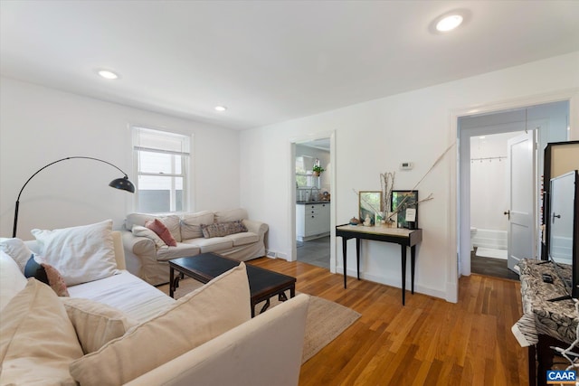 living room with wood finished floors, recessed lighting, and baseboards