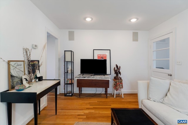 living room with light wood-style flooring and baseboards