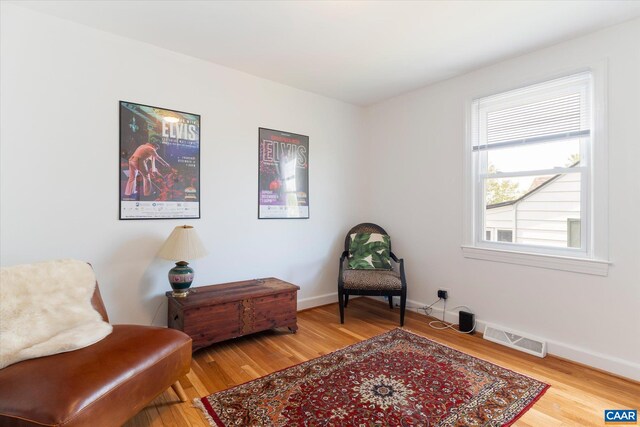 living area with wood finished floors and baseboards