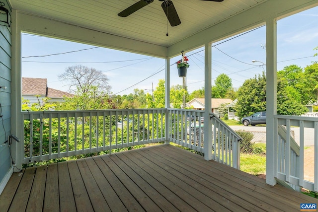 wooden terrace with ceiling fan and covered porch