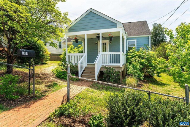 bungalow-style house with covered porch and a shingled roof