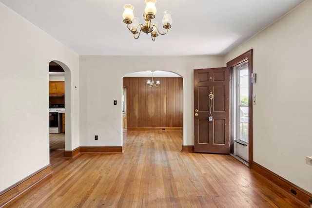 917 Chestnut Dr, Harrisonburg, VA 22801 - entrance foyer with a chandelier, arched walkways, light wood-style floors, and baseboards