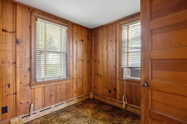 917 Chestnut Dr, Harrisonburg, VA 22801 - empty room featuring baseboard heating, wooden walls, cooling unit, and dark floors