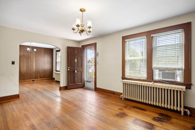 917 Chestnut Dr, Harrisonburg, VA 22801 - entrance foyer with a chandelier, radiator heating unit, arched walkways, cooling unit, and baseboards