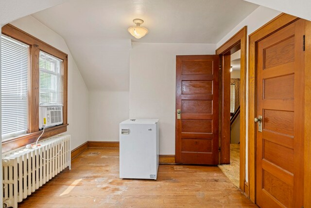 917 Chestnut Dr, Harrisonburg, VA 22801 - additional living space with radiator, light wood-style flooring, vaulted ceiling, baseboards, and cooling unit