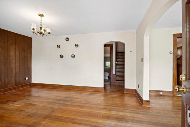 917 Chestnut Dr, Harrisonburg, VA 22801 - unfurnished room featuring arched walkways, wood finished floors, baseboards, and a chandelier