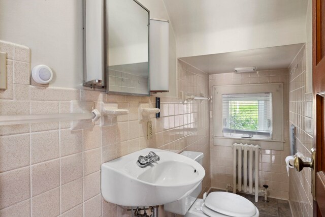 917 Chestnut Dr, Harrisonburg, VA 22801 - half bathroom featuring radiator, a sink, tile walls, and toilet
