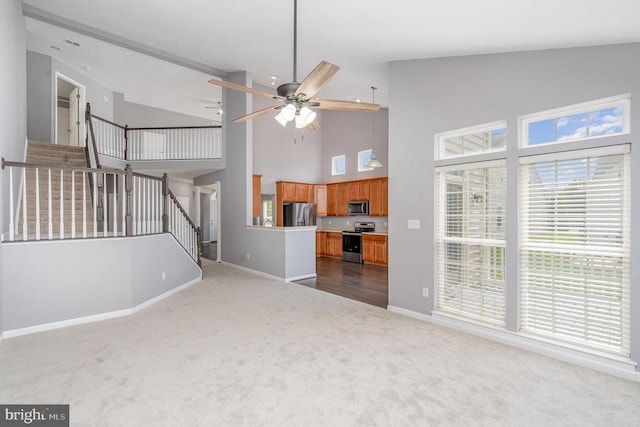 6304 Dranesville Dr W, Fredericksburg, VA 22407 - unfurnished living room featuring dark colored carpet, stairs, high vaulted ceiling, and ceiling fan