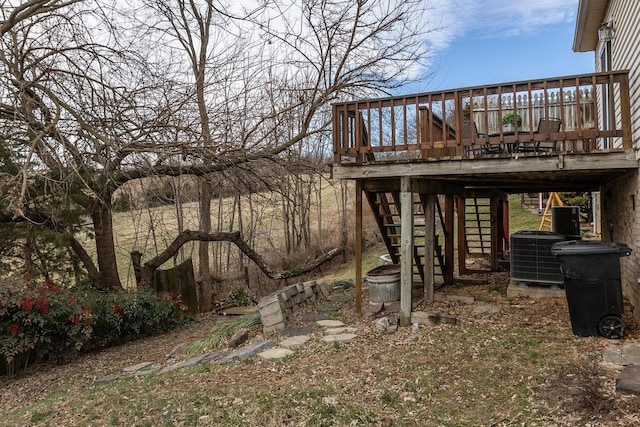 view of yard featuring stairs, central AC unit, and a wooden deck