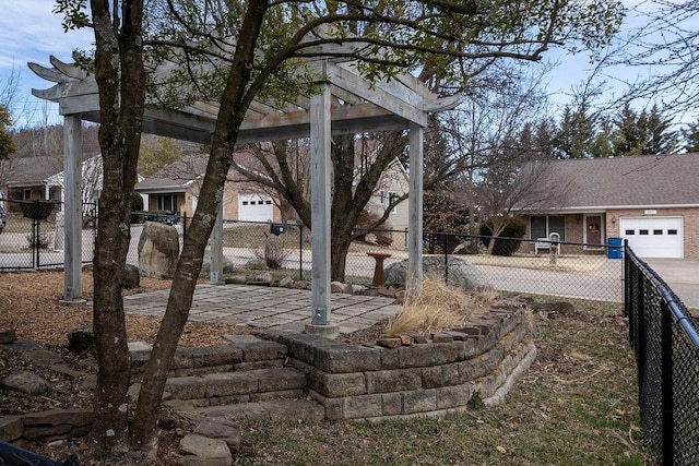 view of yard featuring an attached garage and fence