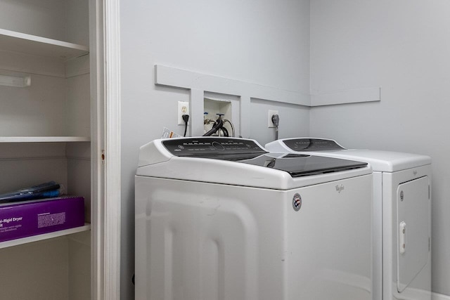 clothes washing area featuring laundry area and washing machine and clothes dryer