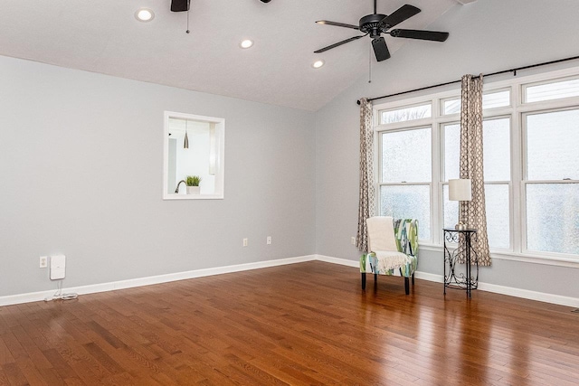 unfurnished room with lofted ceiling, ceiling fan, baseboards, and wood finished floors