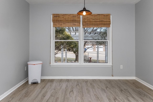 spare room with wood finished floors and baseboards