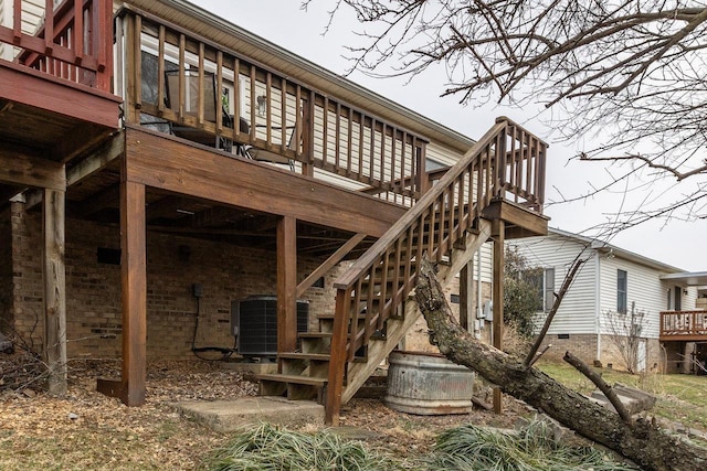 back of house with crawl space, central AC unit, stairway, and a wooden deck