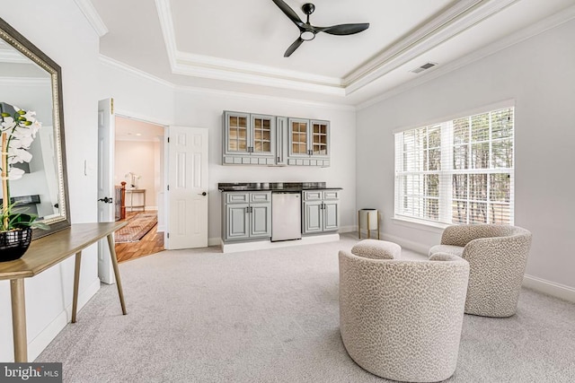 11304 Chivalry Chase Ln, Spotsylvania, VA 22551 - living area with ceiling fan, crown molding, a tray ceiling, light colored carpet, and baseboards