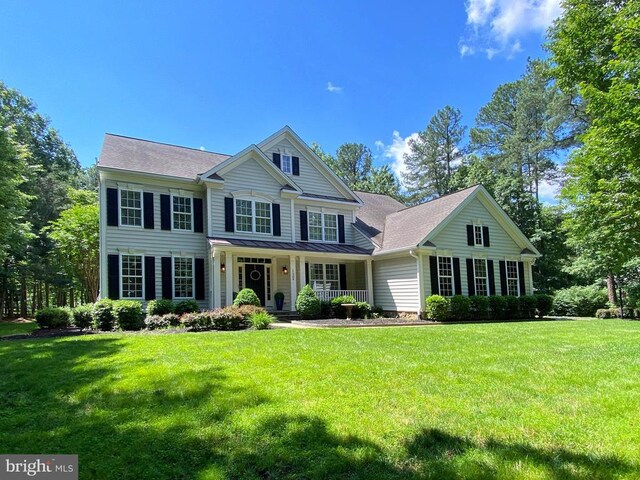 11304 Chivalry Chase Ln, Spotsylvania, VA 22551 - view of front of property with a standing seam roof, a porch, a front yard, and metal roof