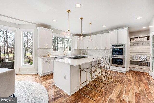 11304 Chivalry Chase Ln, Spotsylvania, VA 22551 - kitchen featuring stainless steel appliances, light wood finished floors, a sink, light countertops, and recessed lighting