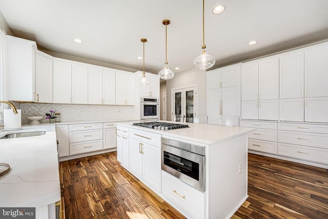 11304 Chivalry Chase Ln, Spotsylvania, VA 22551 - kitchen featuring appliances with stainless steel finishes, a sink, recessed lighting, decorative backsplash, and dark wood-style flooring