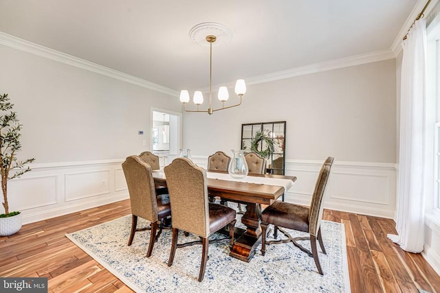11304 Chivalry Chase Ln, Spotsylvania, VA 22551 - dining area with a chandelier, ornamental molding, a wainscoted wall, and wood finished floors