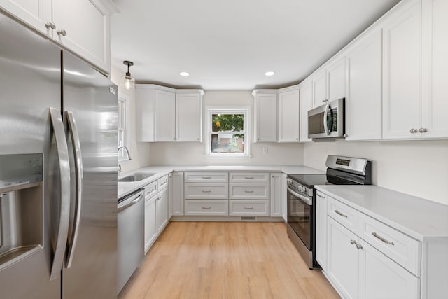 96 Featherstone Dr, Lyndhurst, VA 22952 - kitchen with appliances with stainless steel finishes, a sink, light wood-style flooring, recessed lighting, and light countertops