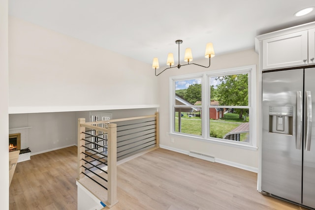 96 Featherstone Dr, Lyndhurst, VA 22952 - staircase with baseboards, wood finished floors, a chandelier, and baseboard heating