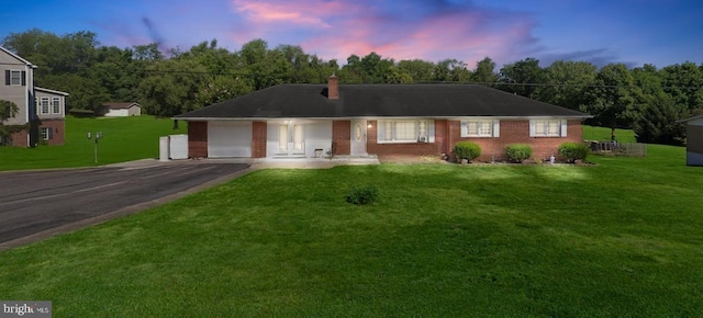 210 Jackson Ave, New Market, VA 22844 - ranch-style home with driveway, brick siding, an attached garage, a chimney, and a front lawn