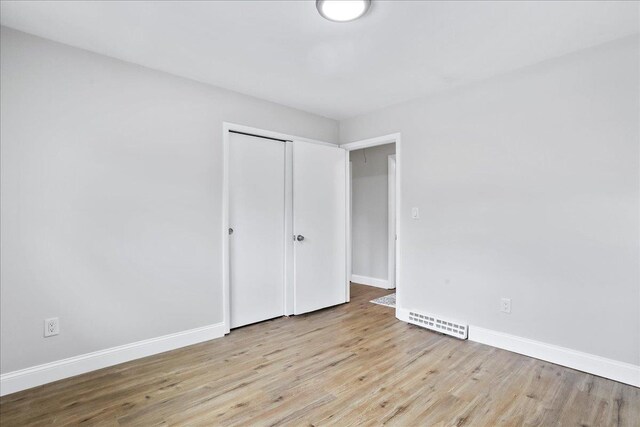 210 Jackson Ave, New Market, VA 22844 - unfurnished bedroom featuring light wood-style flooring, baseboards, and a closet