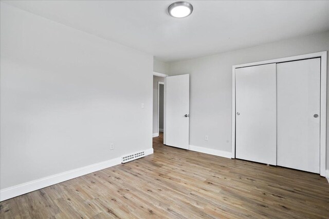 210 Jackson Ave, New Market, VA 22844 - unfurnished bedroom featuring wood finished floors, baseboards, and a closet