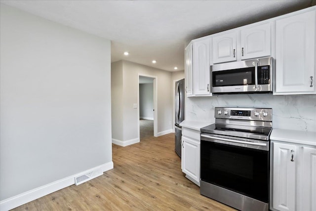 210 Jackson Ave, New Market, VA 22844 - kitchen featuring stainless steel appliances, recessed lighting, white cabinets, light countertops, and baseboards
