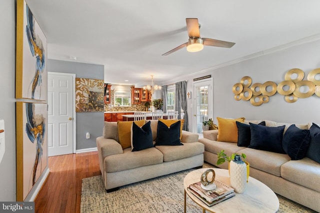 3227 Lancaster Ring Rd, Fredericksburg, VA 22408 - living area with ornamental molding, a chandelier, light wood-type flooring, a ceiling fan, and baseboards