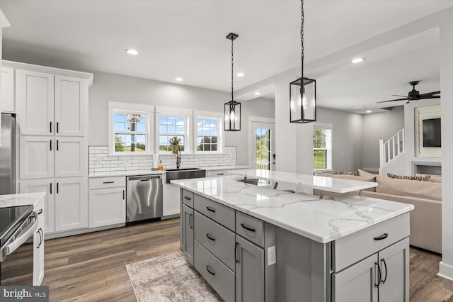 15411 Cedar Hill Dr, Mineral, VA 23117 - kitchen featuring appliances with stainless steel finishes, gray cabinetry, decorative backsplash, dark wood finished floors, and open floor plan