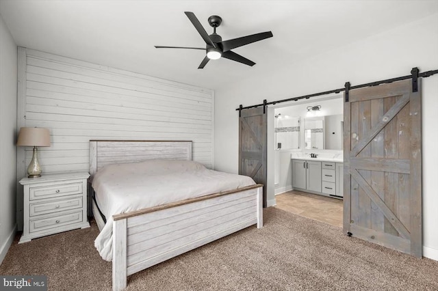 15411 Cedar Hill Dr, Mineral, VA 23117 - bedroom featuring a barn door, light colored carpet, ensuite bath, and a ceiling fan