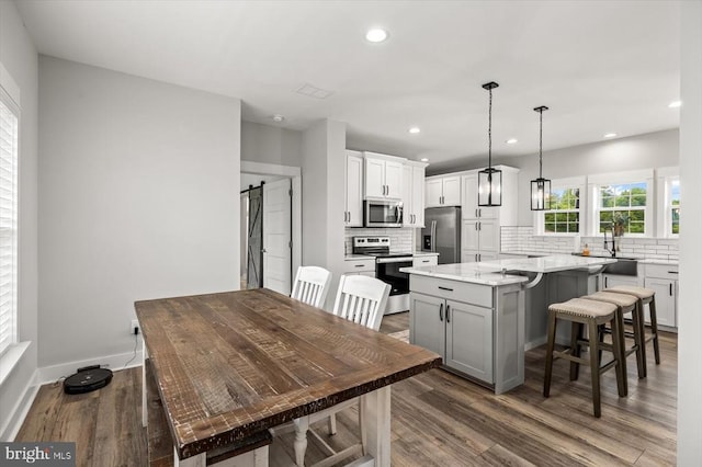 15411 Cedar Hill Dr, Mineral, VA 23117 - kitchen with stainless steel appliances, dark wood-style flooring, backsplash, a center island, and recessed lighting
