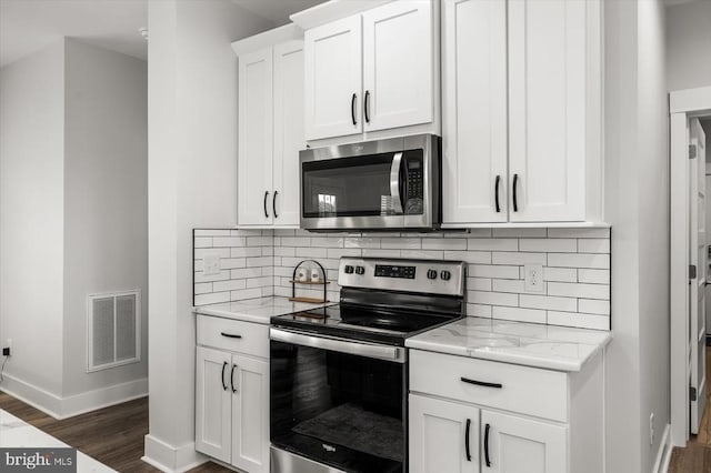 15411 Cedar Hill Dr, Mineral, VA 23117 - kitchen with appliances with stainless steel finishes, dark wood-style flooring, tasteful backsplash, white cabinetry, and light stone counters