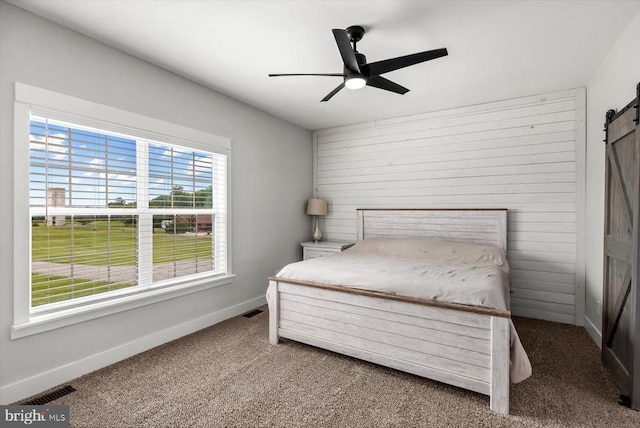 15411 Cedar Hill Dr, Mineral, VA 23117 - carpeted bedroom featuring a barn door and a ceiling fan