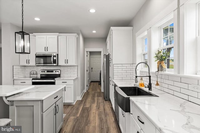 15411 Cedar Hill Dr, Mineral, VA 23117 - kitchen with stainless steel appliances, recessed lighting, dark wood-type flooring, white cabinetry, and decorative light fixtures