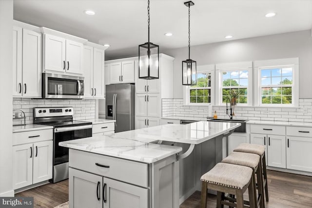 15411 Cedar Hill Dr, Mineral, VA 23117 - kitchen with appliances with stainless steel finishes, a center island, tasteful backsplash, recessed lighting, and white cabinetry