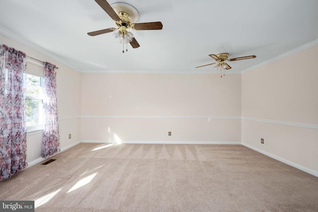 spare room featuring visible vents, baseboards, crown molding, and carpet