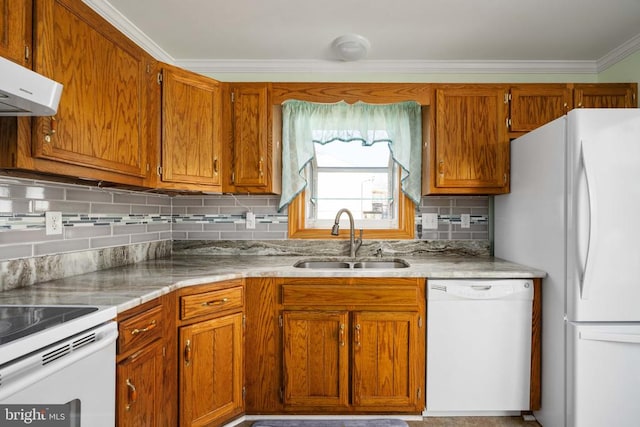 kitchen featuring crown molding, decorative backsplash, brown cabinets, white appliances, and a sink