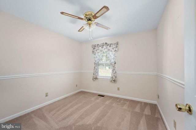 unfurnished room with visible vents, a ceiling fan, baseboards, and carpet floors