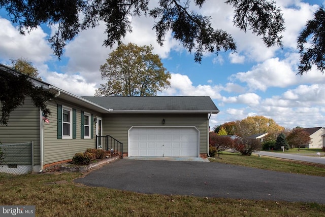 single story home with a garage, driveway, and crawl space