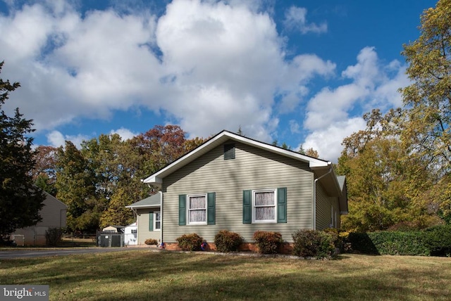 view of home's exterior with a yard